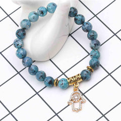 Pulsera con Mano de Fátima (Hamsa) y Flor de Lluvia | Piedras Naturales, Elástica | Joyería Artesanal | Libela Joyería Artesanal Pulsera con Mano de Fátima (Hamsa) y Flor de Lluvia | Piedras Naturales, Elástica | Joyería Artesanal | Libela Joyería Artesanal