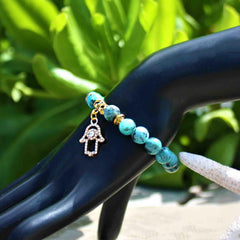 Pulsera con Mano de Fátima (Hamsa) y Flor de Lluvia | Piedras Naturales, Elástica | Joyería Artesanal | Libela Joyería Artesanal Pulsera con Mano de Fátima (Hamsa) y Flor de Lluvia | Piedras Naturales, Elástica | Joyería Artesanal | Libela Joyería Artesanal